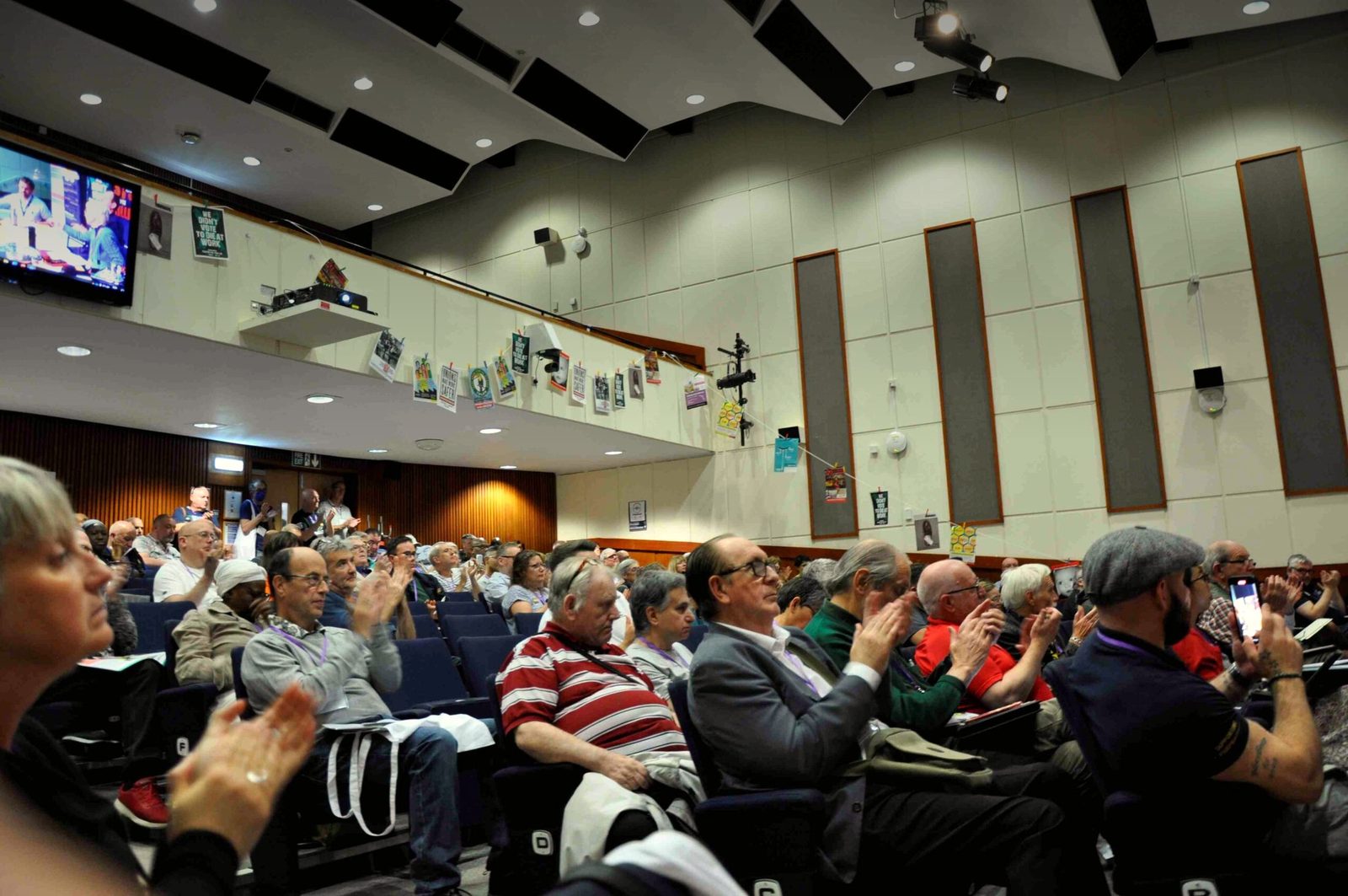 Safety reps applauding in a lecture hall at the National Hazards Conference